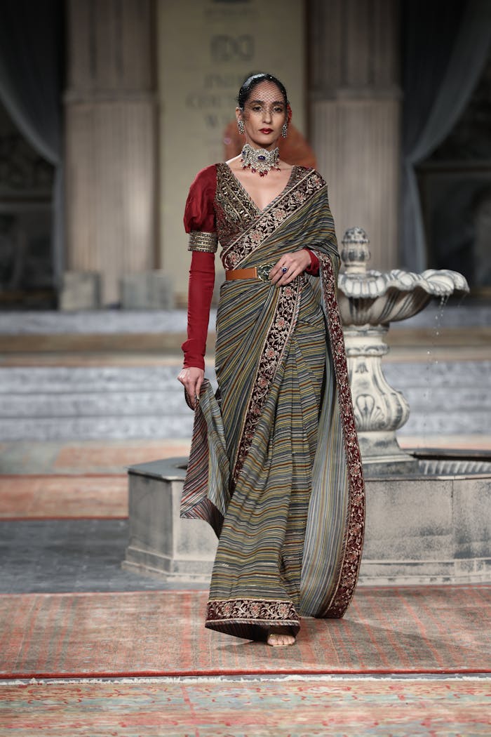 Services-03 Model posing elegantly in a traditional saree at a fashion show.